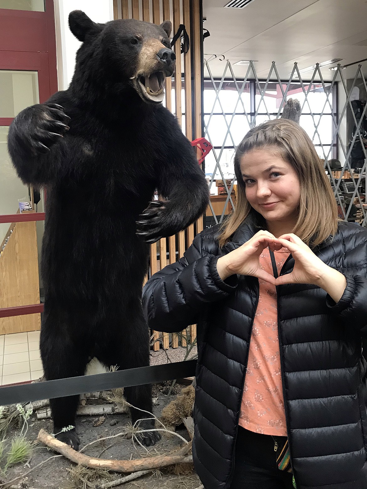 Brooke Sample demonstrates her happiness to be home in Montana in Kalispell’s Glacier International Airport after returning from Peru March 31. (Photo provided)