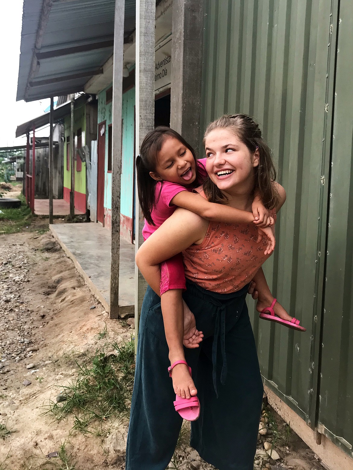 Brooke Sample gives a piggy-back ride while in Peru. (Photo provided)