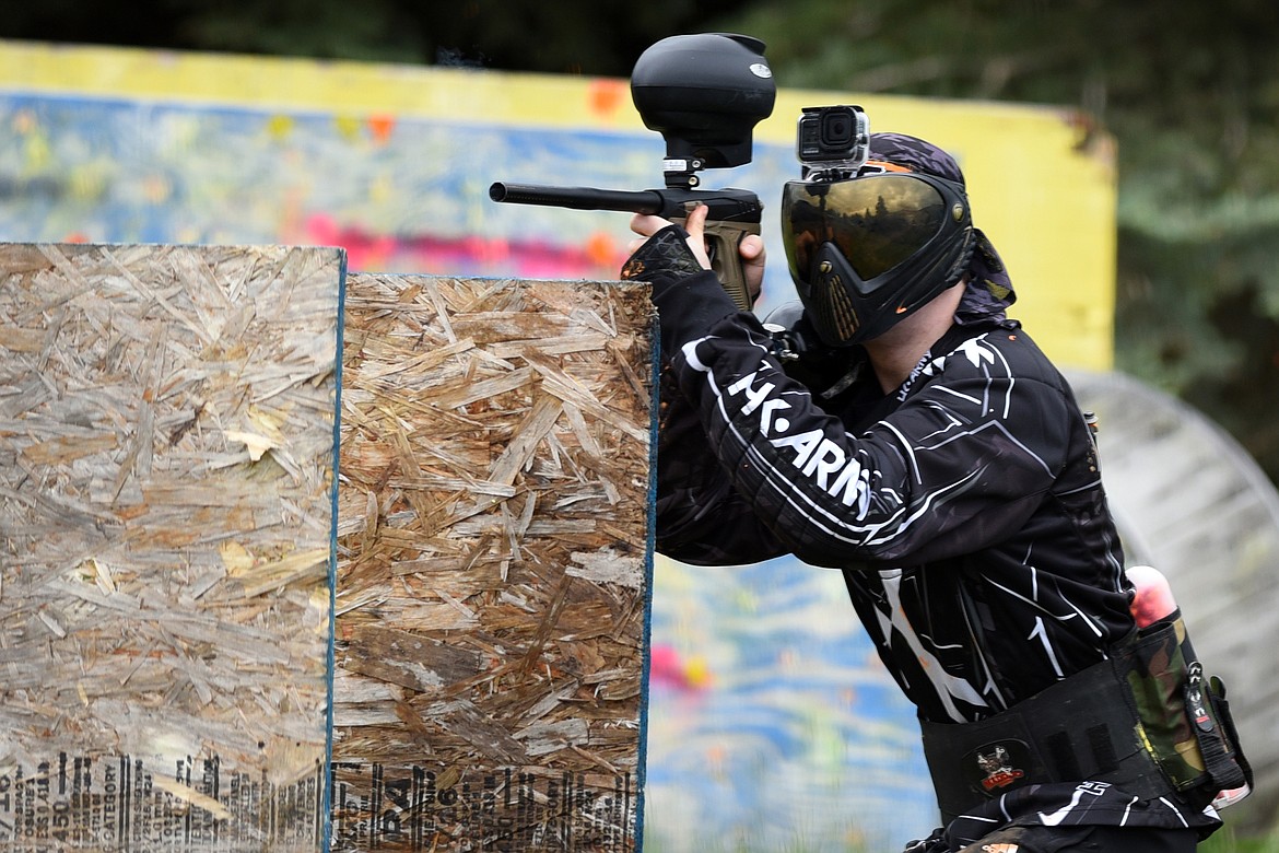 Kian Saadi pops his head up to take a shot during a match at Montana Action Paintball.