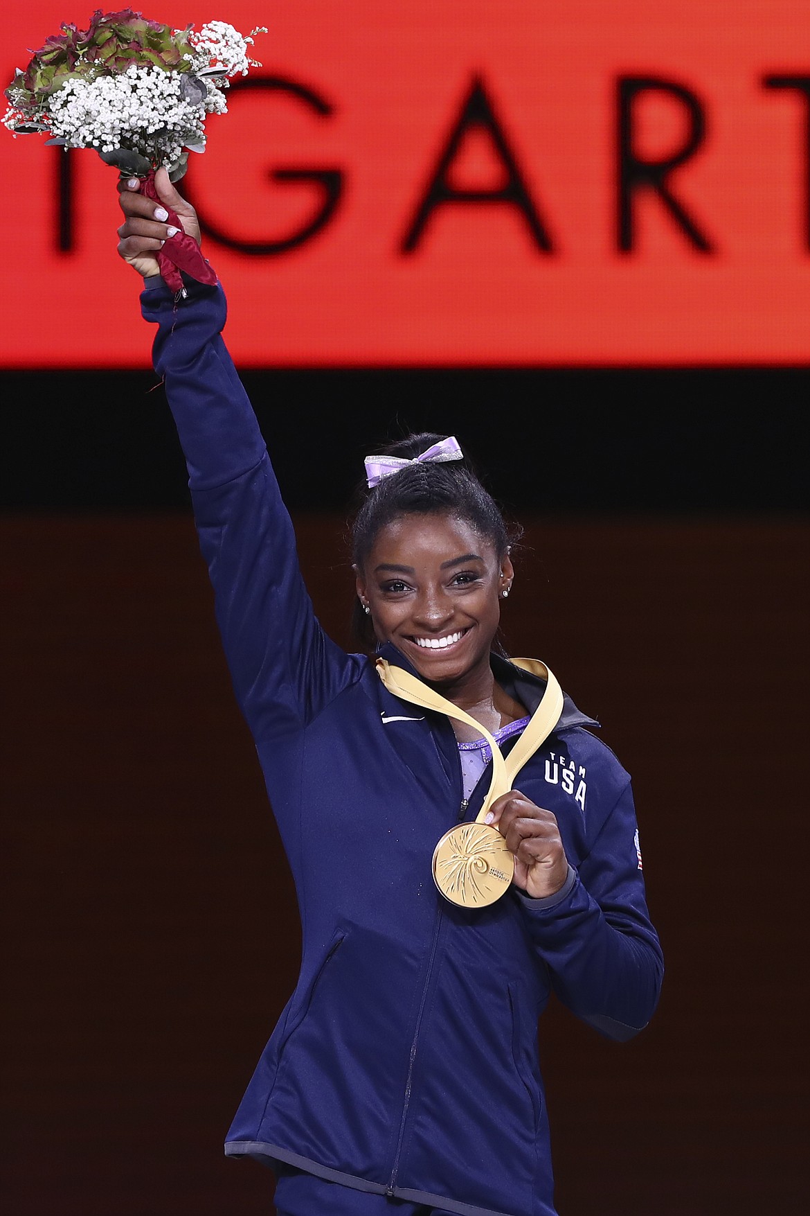 Gold medalist Simone Biles of the United States celebrates during the award ceremony for the balance beam in the women's apparatus finals at the Gymnastics World Championships in Stuttgart, Germany, Sunday, Oct. 13, 2019. (AP Photo/Matthias Schrader)