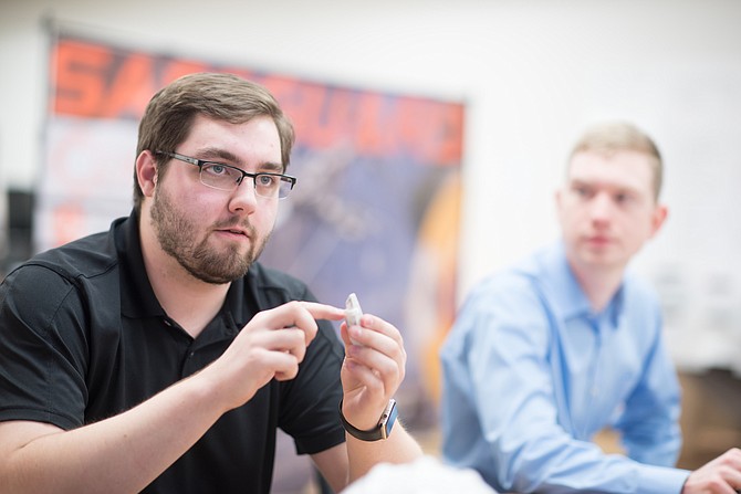 University of Idaho computer science major and Co-op Education student Garrett Oetken, left, discusses the Compass energy detection device during a meeting last fall. Also pictured: Safeguard co-founder and CTO John Thompson.