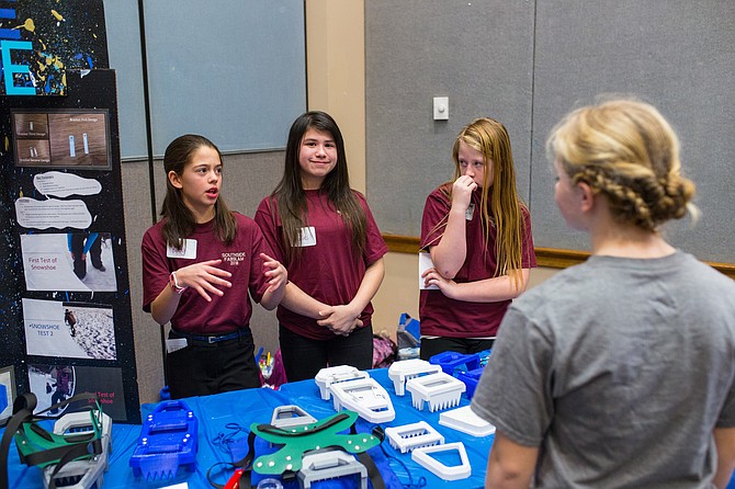 Ruby Jiles, Sadie Etzwiler and Payton Jackson from Southside Elementary School in Cocolalla show another North Idaho student the 3D-printed prototypes of collapsible snowshoes their team designed for the inaugural North Idaho FabSLAM Student Showcase at Lewis-Clark State College in Lewiston in 2018. The event was staged by the Idaho STEM Action Center, which launched the MakerMinded program throughout the Gem State today in partnership with Lightweight Innovations for Tomorrow (LIFT). The MakerMinded digital platform expands student and school access to world-class advanced manufacturing and science, technology, engineering and math learning experiences, and highlights student competition.