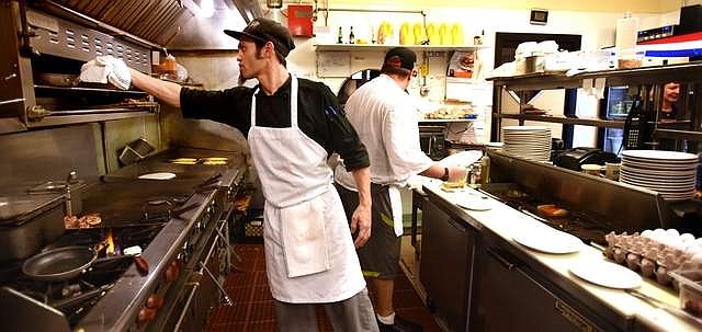 Adam Davis and Logan Haney man the grill at Loula's on Thursday morning, September 19.