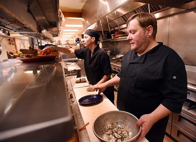 Josh Auerhammer and Sara Penneman, line cooks at Sykes in Kalispell, keep going even after the lunch rush has ended. The diner has reduced its hours to 7 a.m. to 3 p.m., but they are still open seven days a week.