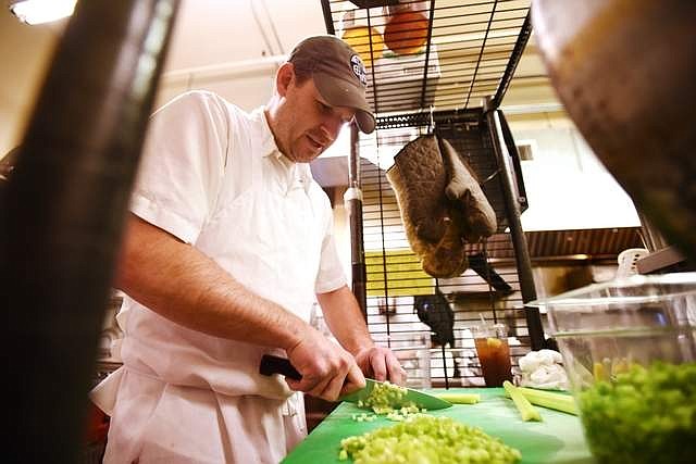 Shaun McCollum, general manager and executive chef at Loula's chops celery as he prepares to make gumbo on Thursday morning, September 19. McCollum said Loula's had to reduce their hours to only serve breakfast and lunch because they could not get enough staff to keep the restaurant open all day.