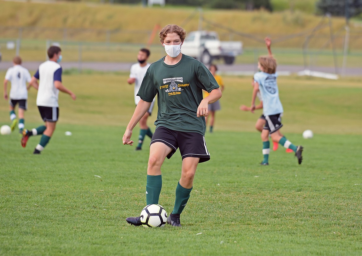 Whitefish junior defender Willem Gray kicks the ball to a teammate during practice on Aug. 20 at Smith Fields. (Whitney England/Whitefish Pilot)