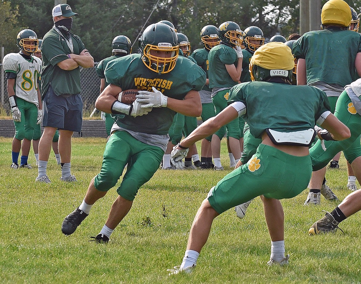 Bulldog reciever Dennis Shestak runs a route around the defense during practice on Aug. 20 at Whitefish High School. (Whitney England/Whitefish Pilot)