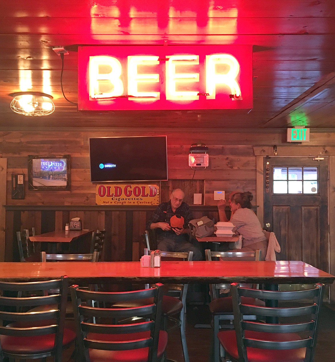 A beer sign sits high above customers at the Hilltop.