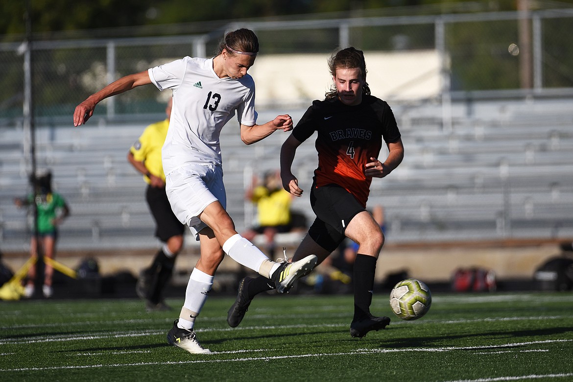 Glacier’s Sol Dalla Betta (13) looks to shoot against Flathead’s Aiden Christy (4) during crosstown soccer at Legends Stadium on Thursday. (Casey Kreider/Daily Inter Lake)