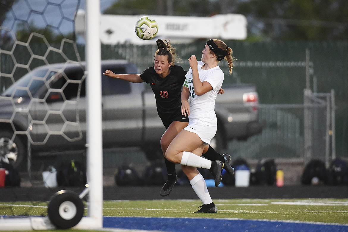 Flathead’s Ashlynn Whiteman (10) and Glacier’s Kenzie Williams (12) battle for a header near the Glacier goal during crosstown soccer at Legends Stadium on Thursday. (Casey Kreider/Daily Inter Lake)