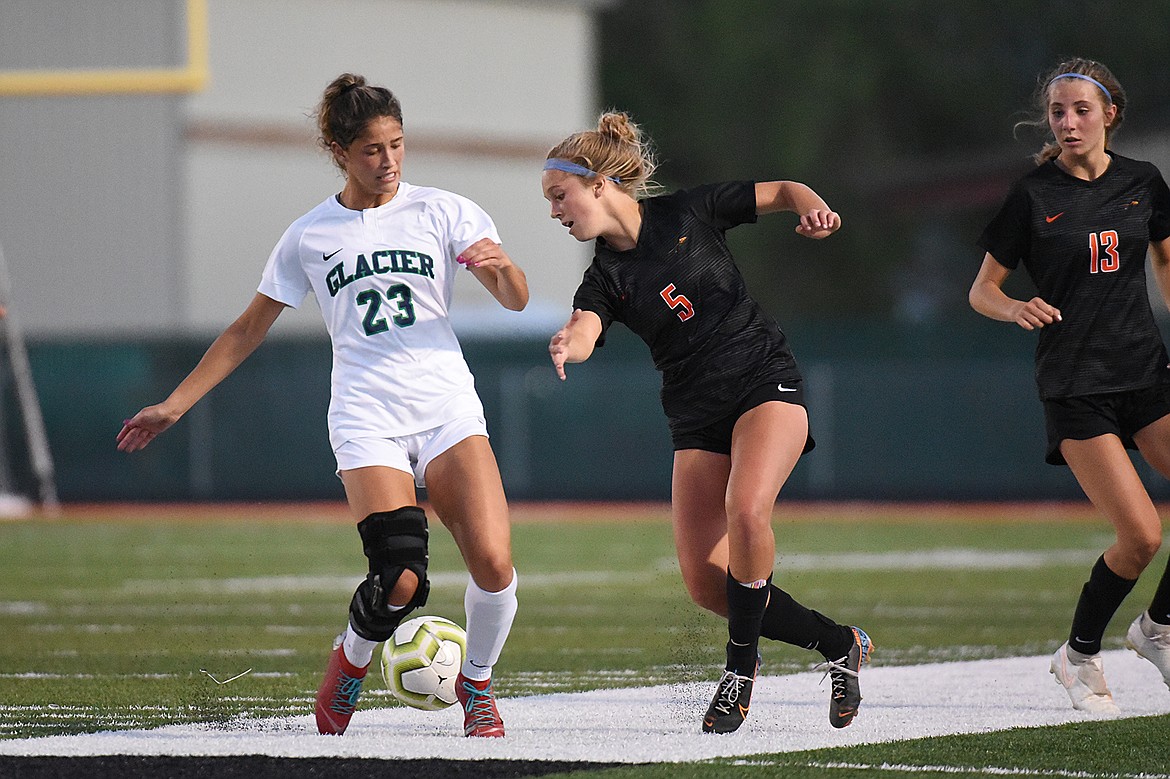 Glacier’s Taylor Brisendine (23) and Flathead’s Ellie Hawes (5) battle for possession during crosstown soccer at Legends Stadium on Thursday. (Casey Kreider/Daily Inter Lake)