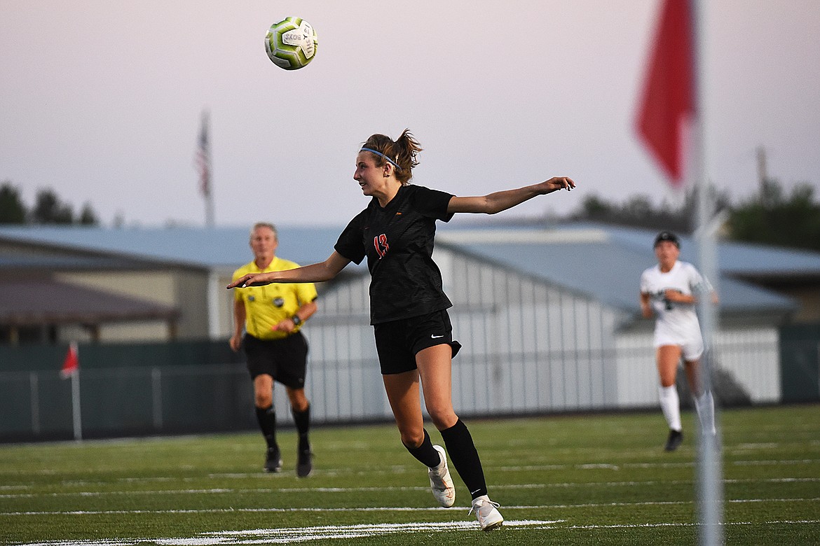 Flathead’s Tessa Smith (13) plays the ball off her head against Glacier during crosstown soccer at Legends Stadium on Thursday. (Casey Kreider/Daily Inter Lake)
