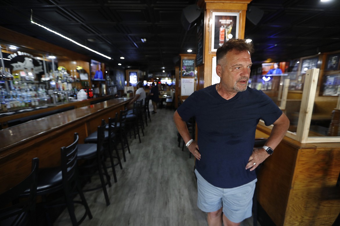 This photo shows Perry Porikos, owner of the The Brown Jug restaurant, in Ann Arbor, Mich. The Greek immigrant arrived here more than four decades ago as a 20-year-old soccer player for the Wolverines and part-time dishwasher at restaurant, which he now owns. (AP Photo/Paul Sancya)