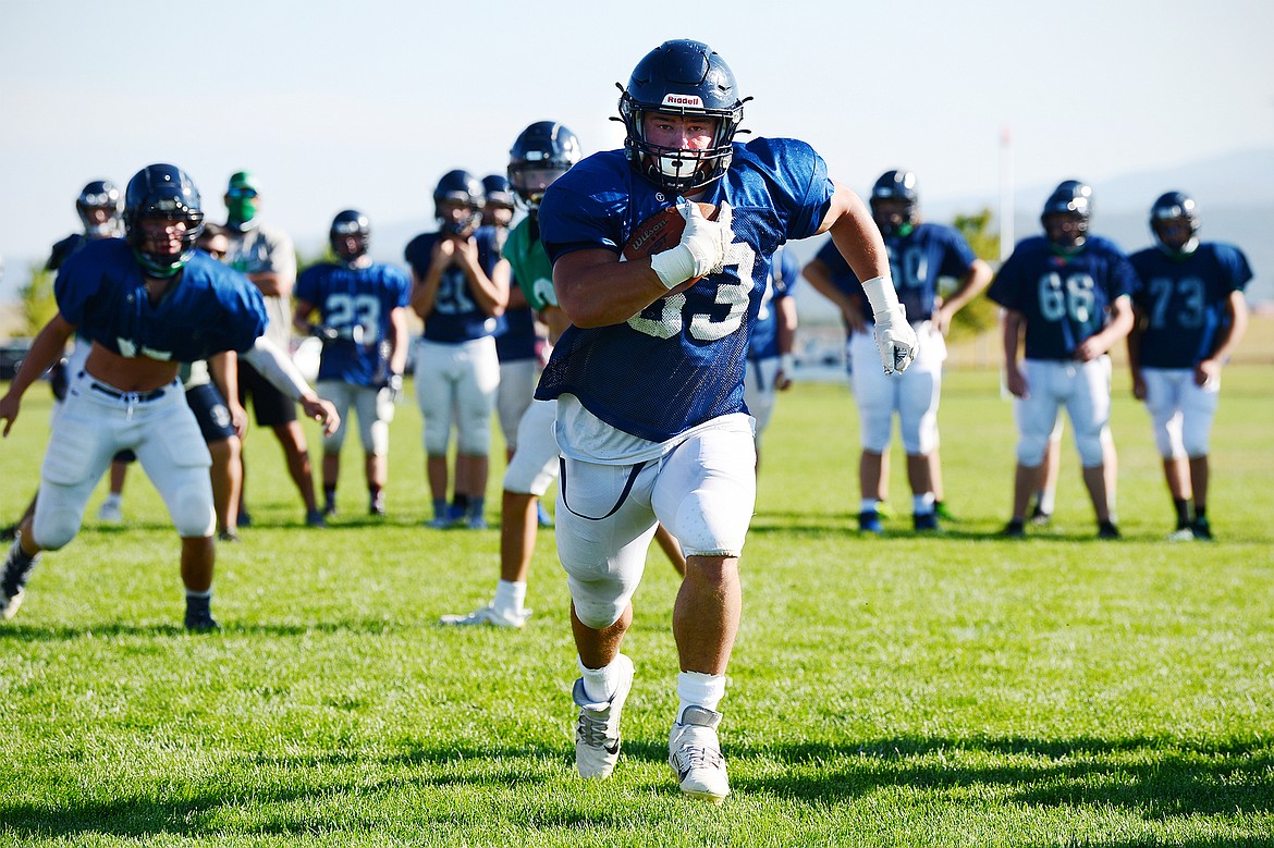 Glacier running back Jake Rendina takes a handoff into the end zone during practice at Glacier High School on Wednesday, Aug. 26. (Casey Kreider/Daily Inter Lake)