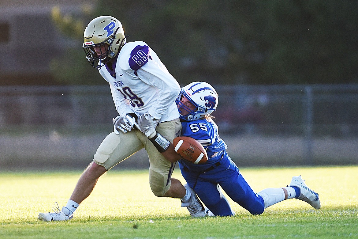 Columbia Falls linebacker Lucas Thacker (55) forces a fumble by Polson tight end Braunson Henriksen (89) in the second quarter at Satterthwaite Memorial Field on Friday. The Wildcats recovered the fumble. (Casey Kreider/Daily Inter Lake)