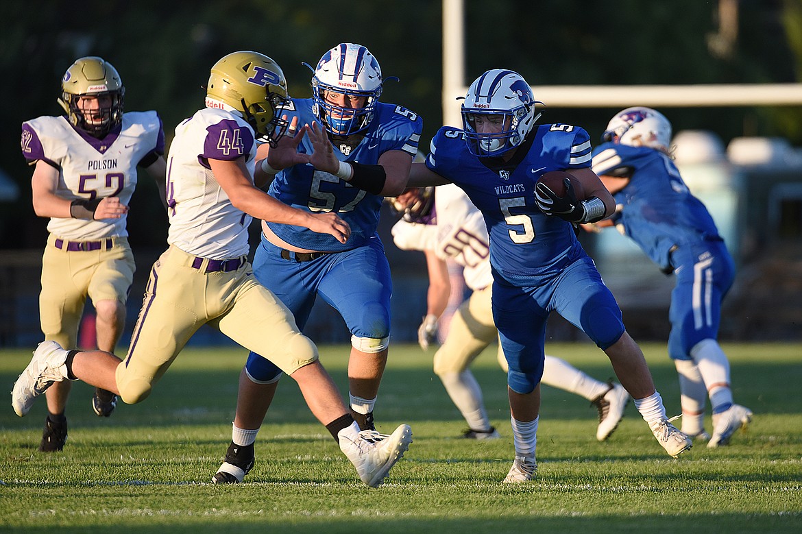 Columbia Falls running back Isaiah Roth (5) looks for room to run against Polson at Satterthwaite Memorial Field on Friday. (Casey Kreider/Daily Inter Lake)