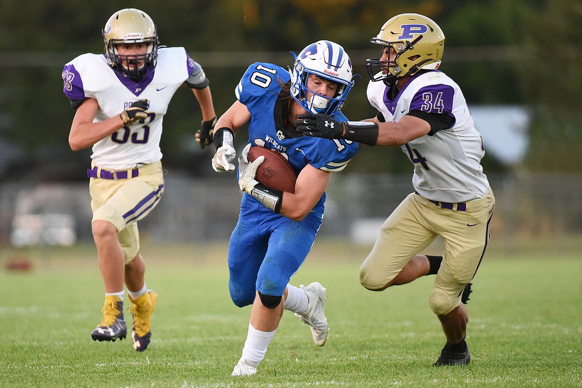 Columbia Falls wide receiver Cade Morgan (10) is brought down by Polson’s Boston Goode (34) after a second-quarter reception at Satterthwaite Memorial Field on Friday. (Casey Kreider/Daily Inter Lake)