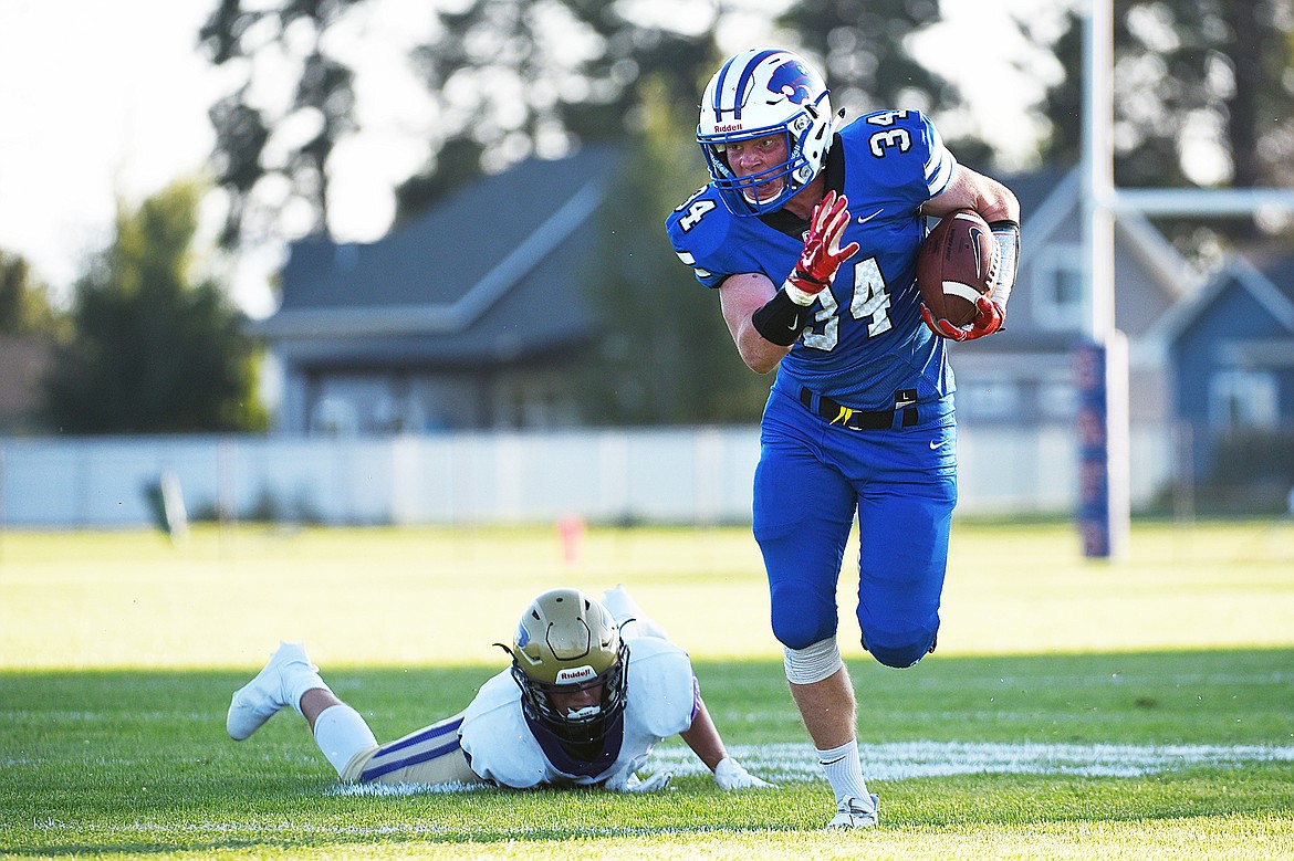 Columbia Falls wide receiver Jordan Knapton (34) runs after making a first-quarter reception against Polson at Satterthwaite Memorial Field on Friday. (Casey Kreider/Daily Inter Lake)