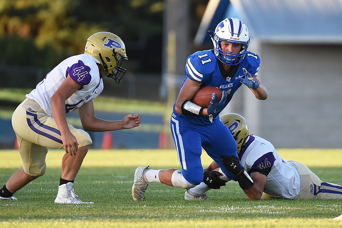 Columbia Falls wide receiver Zane McCallum (11) looks for room to run after a reception against Polson at Satterthwaite Memorial Field on Friday. (Casey Kreider/Daily Inter Lake)