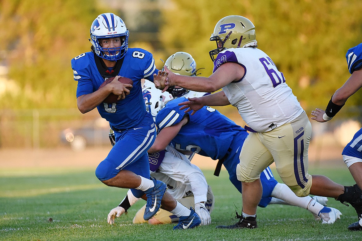 Columbia Falls quarterback Mason Peters (8) is pressured out of the pocket by Polson defenders during the first half at Satterthwaite Memorial Field on Friday. (Casey Kreider/Daily Inter Lake)