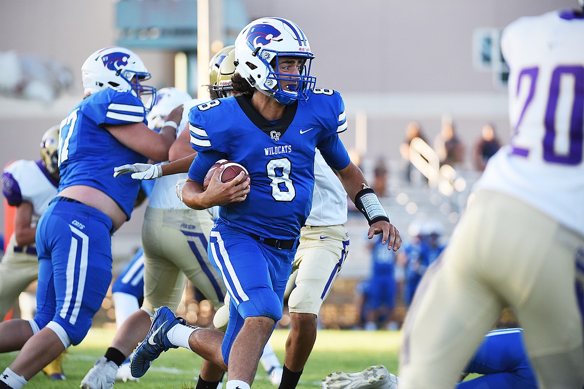 Columbia Falls quarterback Mason Peters (8) looks for room to run in the first half against the Polson defense at Satterthwaite Memorial Field on Friday. (Casey Kreider/Daily Inter Lake)