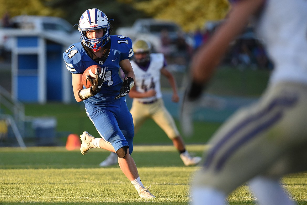 Columbia Falls wide receiver Taylor Bryan (14) looks for room to run after a reception in the first half against Polson at Satterthwaite Memorial Field on Friday. (Casey Kreider/Daily Inter Lake)