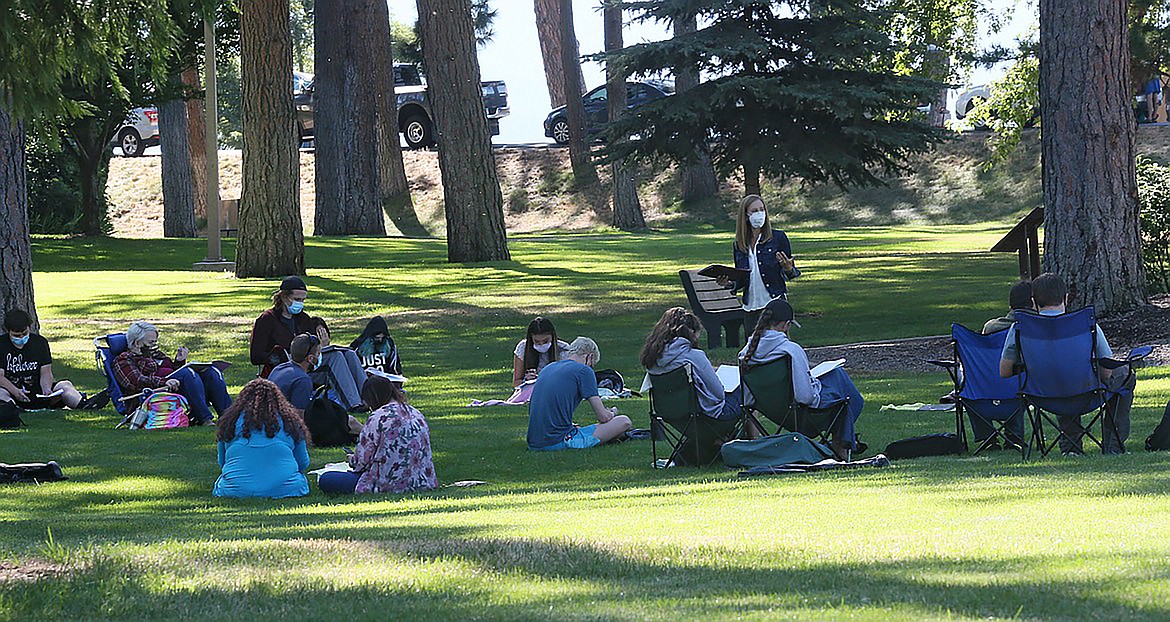 English instructor Nikole King teaches class on the lawn and in the open air Friday morning at North Idaho College.