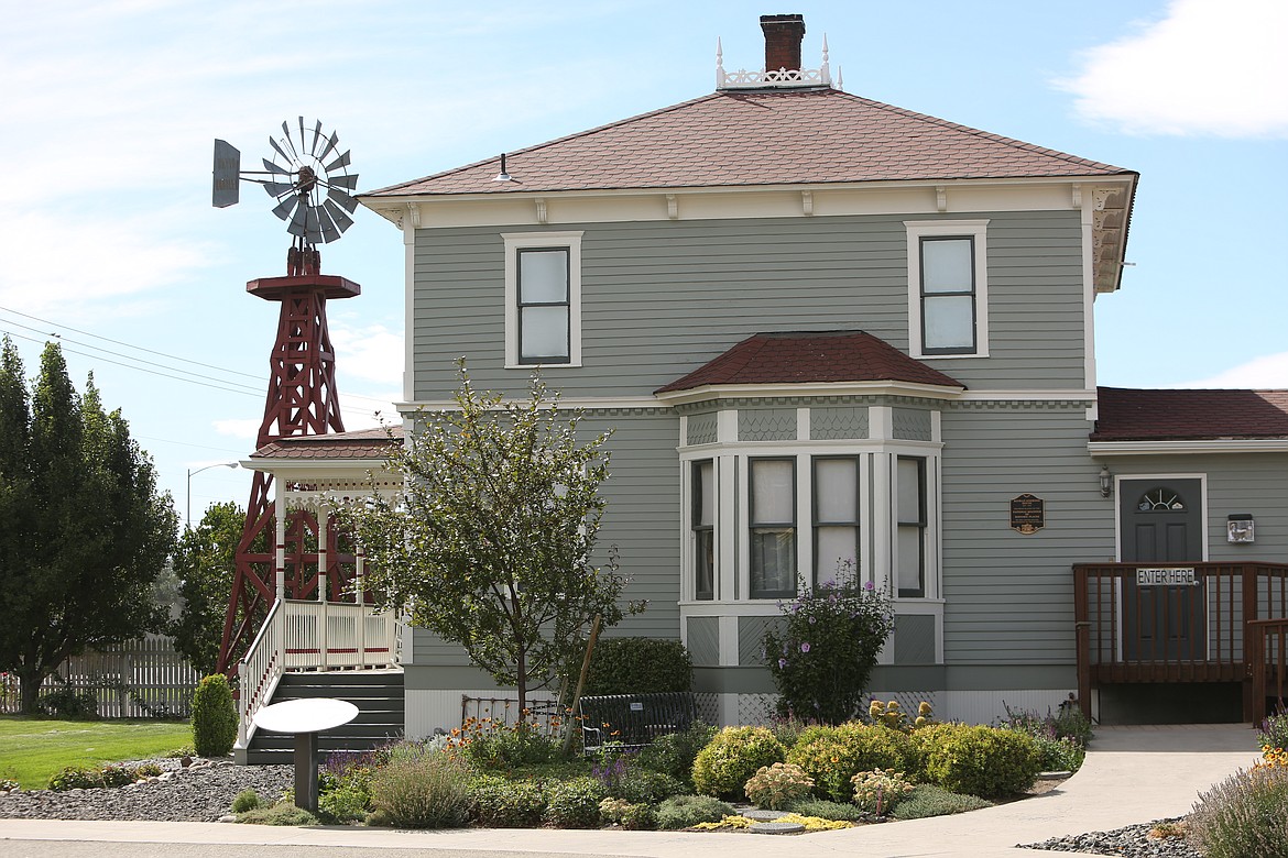 The Reiman-Simmons House, originally built at the beginning of the 20th century, is the cornerstone of the Quincy Valley Historical Society and Museum. While it is original to the site, many adjacent features such as the windmill were moved here to replace structures that couldn't be restored. The building is wreathed by flowers planted by resident and master gardener Lana Lubach, while the lawn connecting the different buildings is regularly trimmed by Tom Snyder, both of whom are among the many volunteers who support the facility.