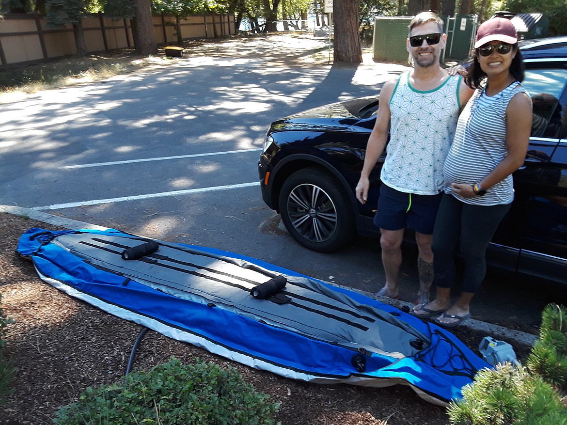 CRAIG NORTHRUP/Press
Simon Mamic and Catherine Munoz of Seattle wait for their inflatable kayak to rise. Travel dollars have taken a hit from the pandemic, but Idaho's re-opening has drawn tourists to the Coeur d'Alene area to save what was going to be a lost summer.