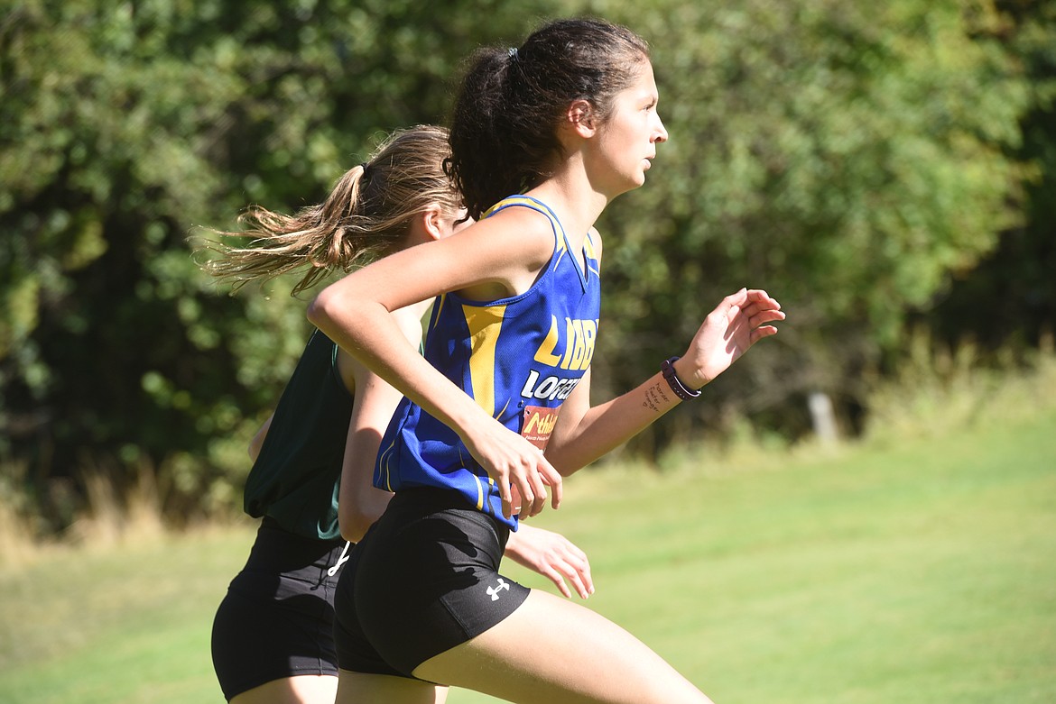 Aurora Smith, a sophomore on Libby High School women's varsity cross country team, powers past an opponent at the Libby Invitation meet held at Cabinet View Golf Course Aug. 29.