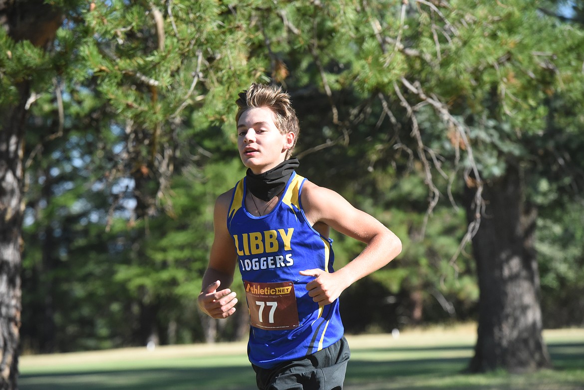 Evan Jenks, a junior on Libby High School men's varsity cross country team, runs at the Libby Invitational meet held at Cabinet View Golf Course Aug. 29.