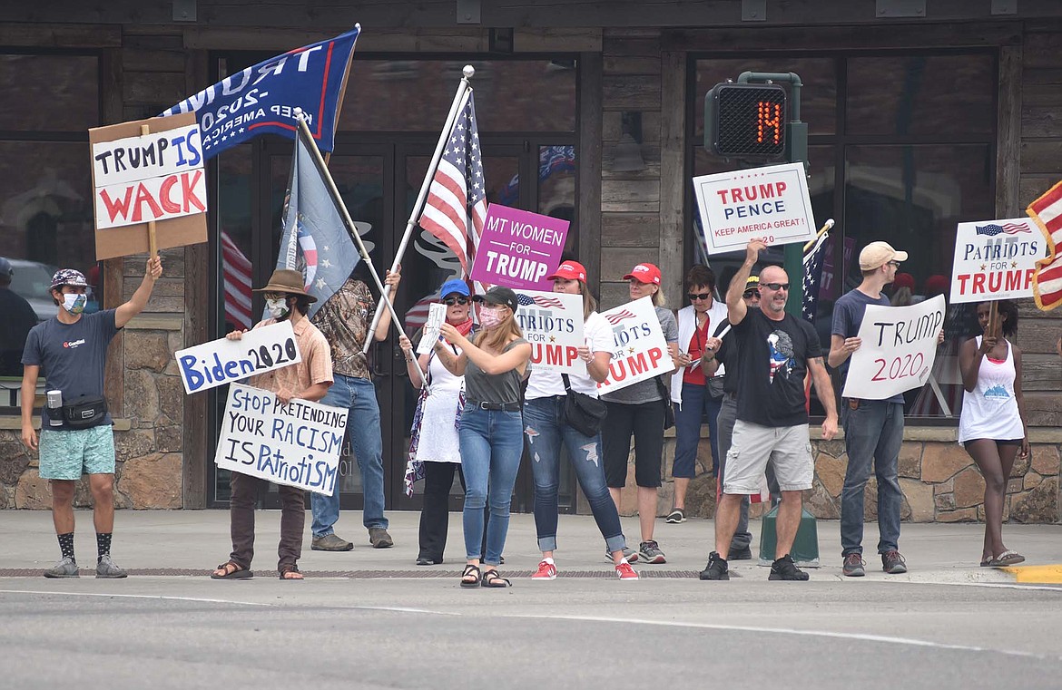 Supporters of Republican President Donald Trump, supporters of presidential candidate Democrat Joe Biden, along with those showing support for the Black Lives Matter movement stand near each other at the corner of Second Street and Baker Avenue on Monday, Aug. 24. (Heidi Desch/Whitefish Pilot)