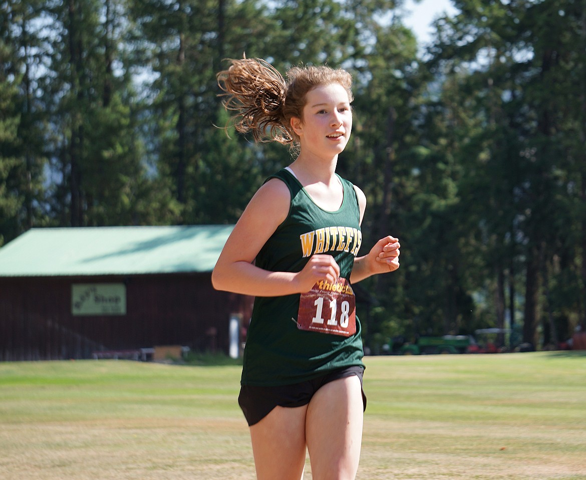 Bulldog freshman Hazel Gawe runs at the Libby Invitational cross-country meet last weekend. She finished second in the junior varsity race. (Matt Weller photo)