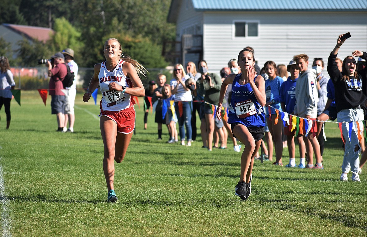 Sophomore Ara Clark attempts to beat out Coeur d'Alene's Anne Marie Dance during Friday's home meet.