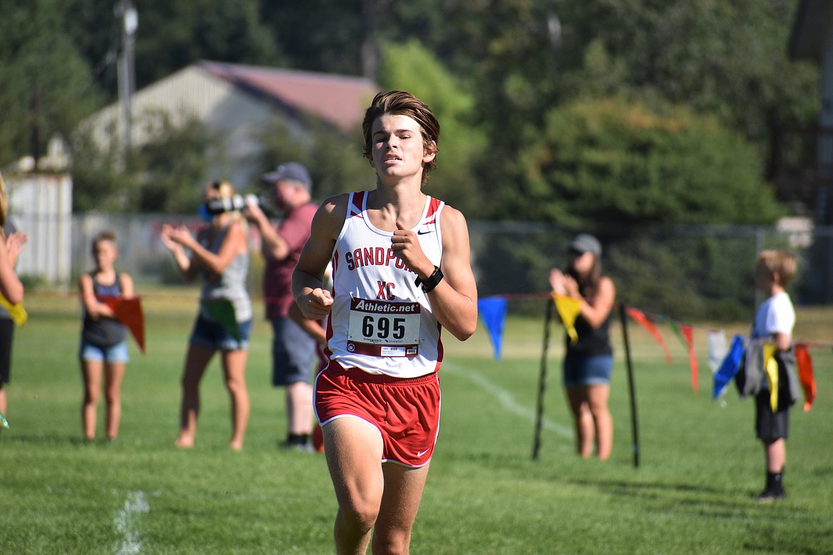 Junior Trey Clark nears the finish line during Friday's meet.