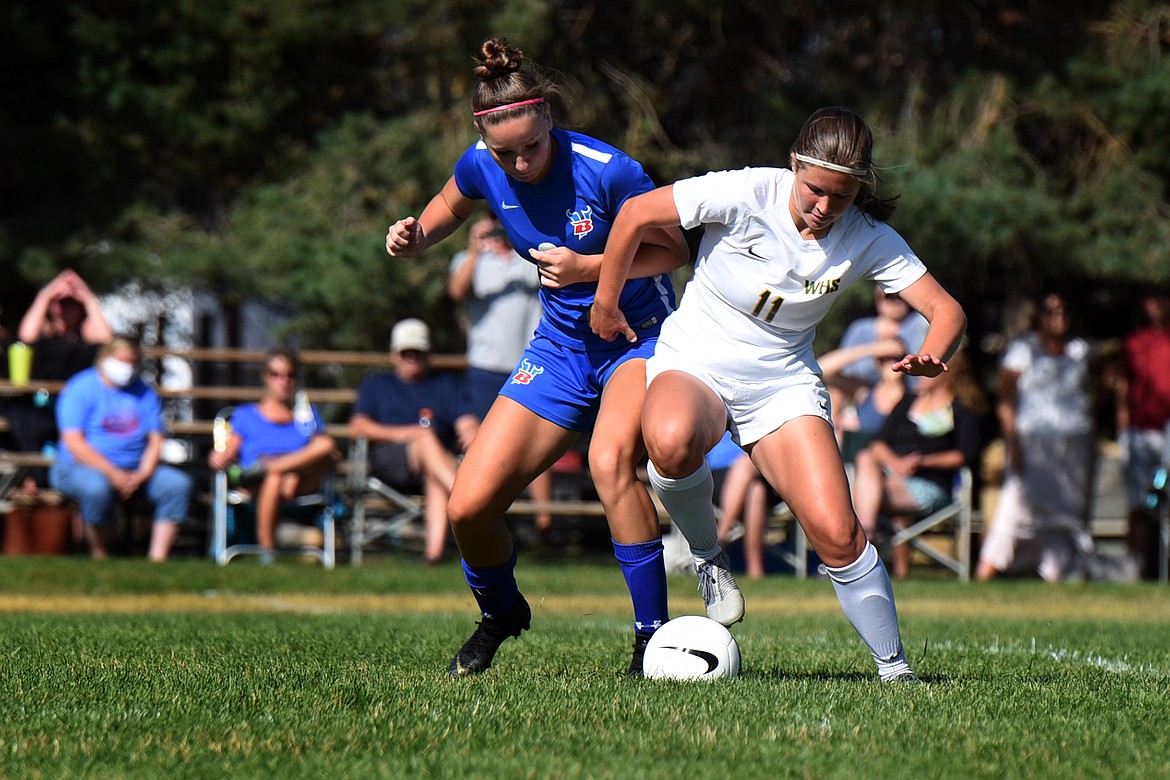 Whitefish's Emma Barron (11) battles Bigfork's Brette Guenzler for the ball Saturday as the teams fought to a 4-4 tie in Bigfork. (Jeremy Weber/Daily Inter Lake)