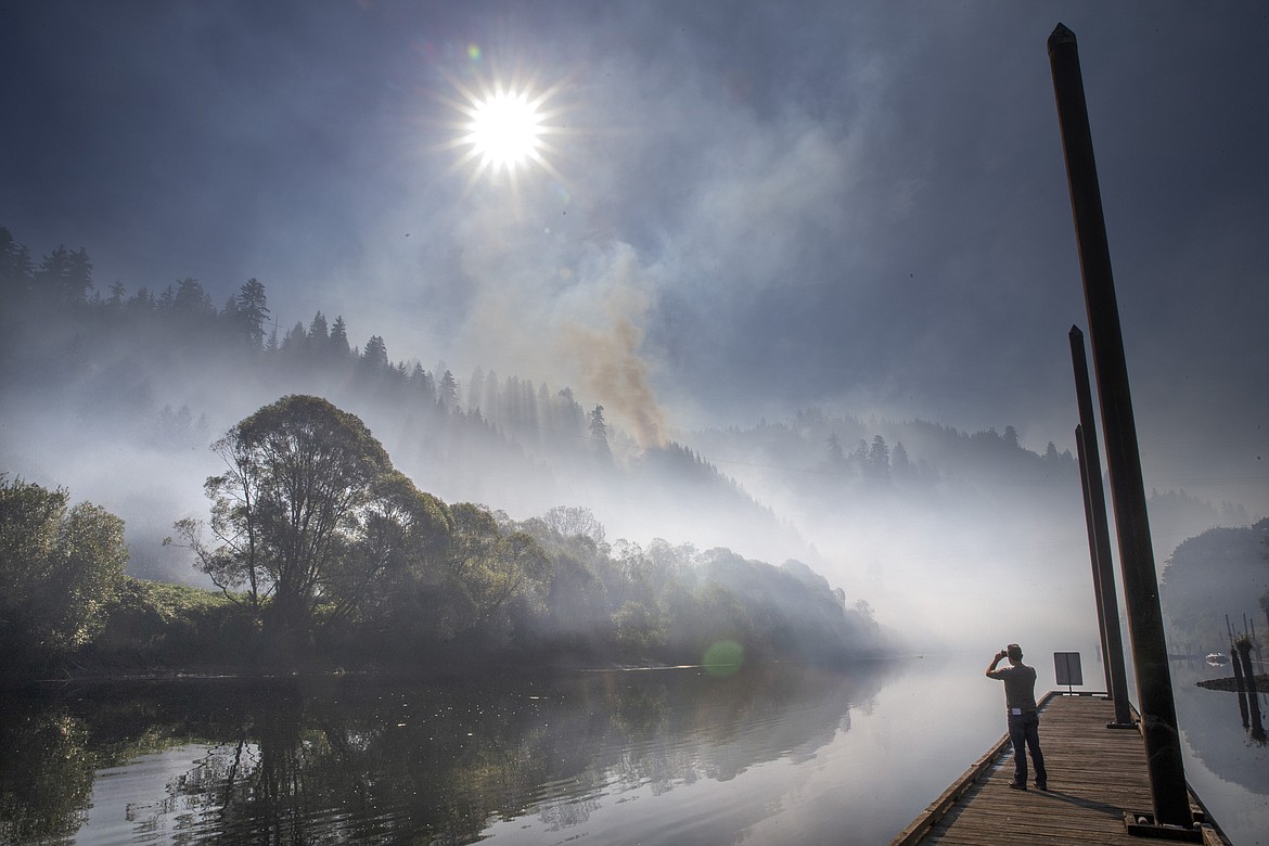 Chris Pietsch/The Register-Guard via AP
Smoke hangs over the Siuslaw River near Mapleton, Ore., Tuesday, as the The Sweet Creek Milepost 2 Fire burns on the hillside overlooking the town.