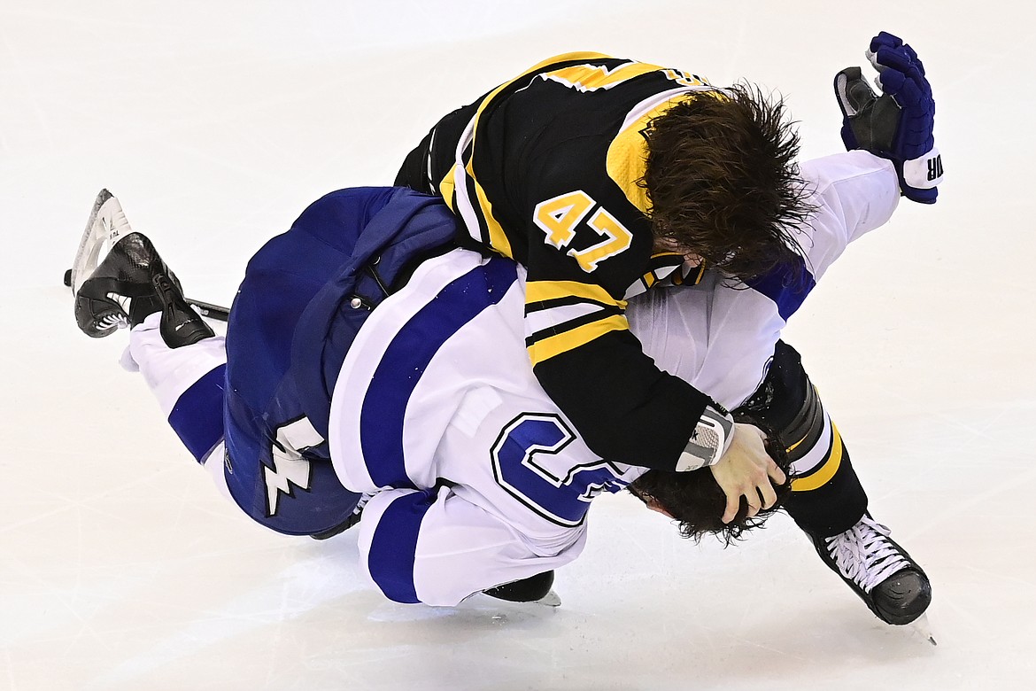 Boston Bruins defenseman Torey Krug (47) fights with Tampa Bay Lightning center Tyler Johnson (9) during the second period of Game 3 of an NHL hockey second-round playoff series, Wednesday, Aug. 26, 2020, in Toronto. (Frank Gunn/The Canadian Press via AP)