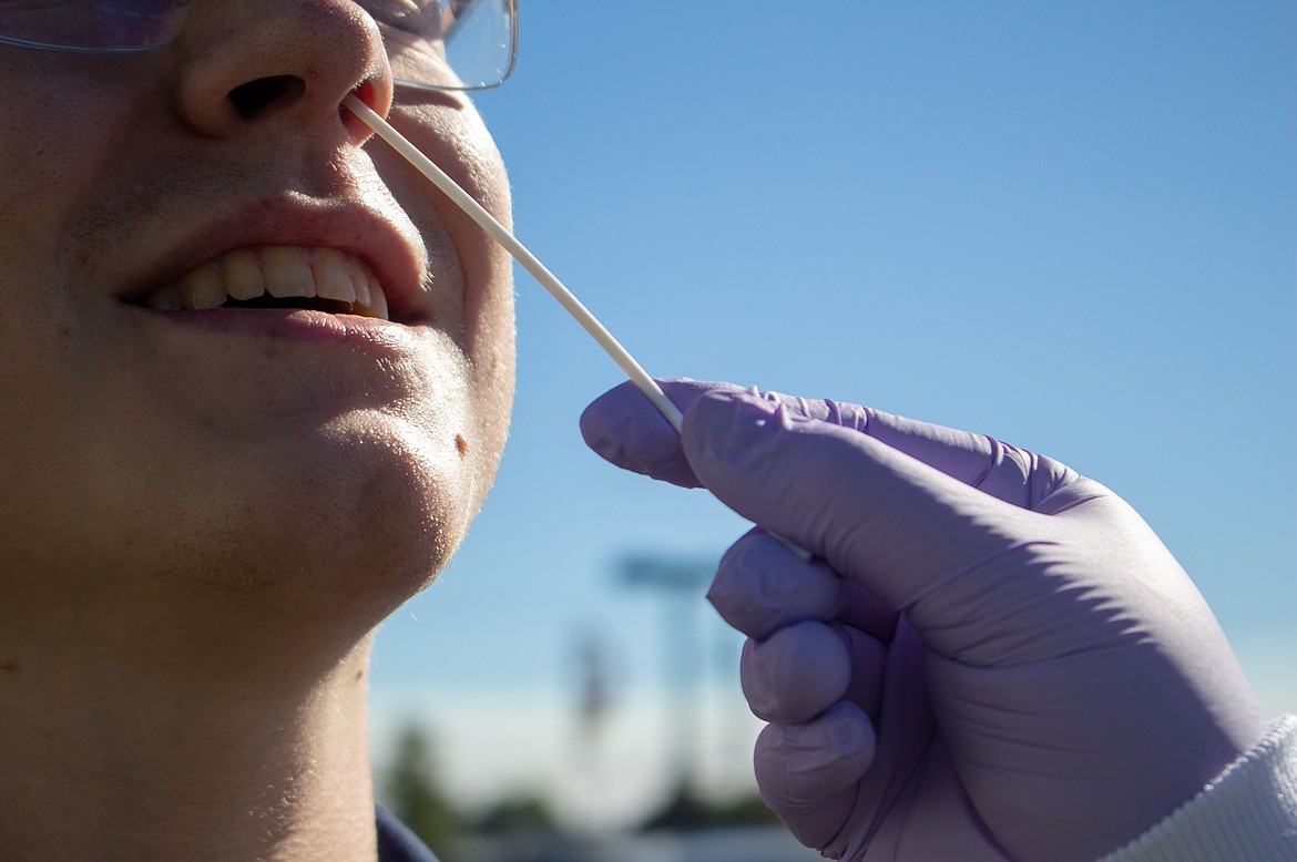 Cheryl Adams inserts a nasal swab about an inch into the nose to conduct Confluence's new antigen test. The more common PCR coronavirus tests are notorious for being inserted significantly deeper into the nasal passage, often causing discomfort.