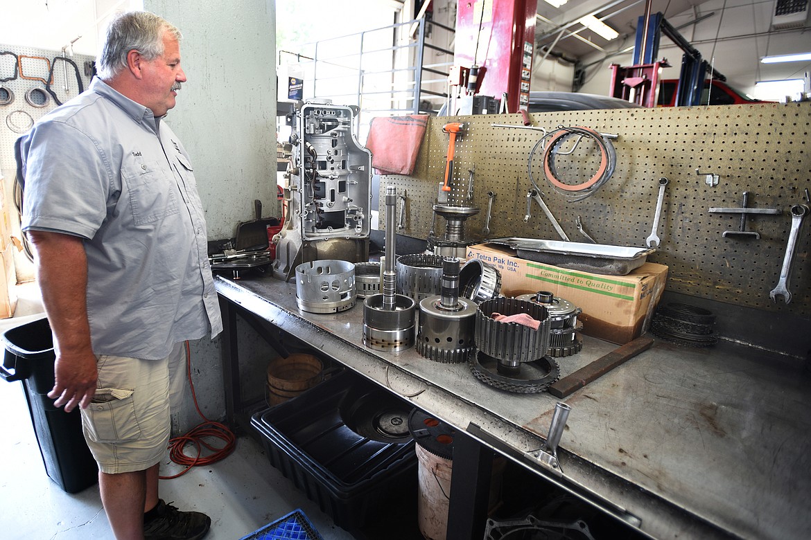 Todd Napier, owner and manager of Flathead Transmission Specialists, looks over a dissassembled transmission.