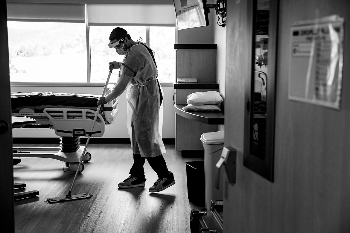 After patients discharge home the vacated rooms are intensely cleaned and disinfected before another patient can be admitted. Tim Dietz mops the floor as part of this “terminal cleaning” process that takes close to an hour to complete.
