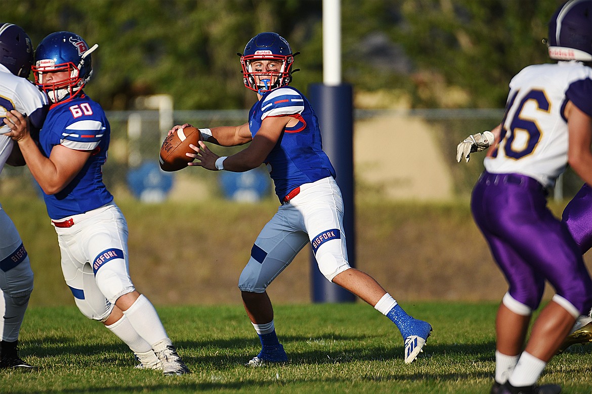 Bigfork quarterback Patrick Wallen (2) looks to throw in the first quarter against Cut Bank at Bigfork High School on Friday. (Casey Kreider/Daily Inter Lake)