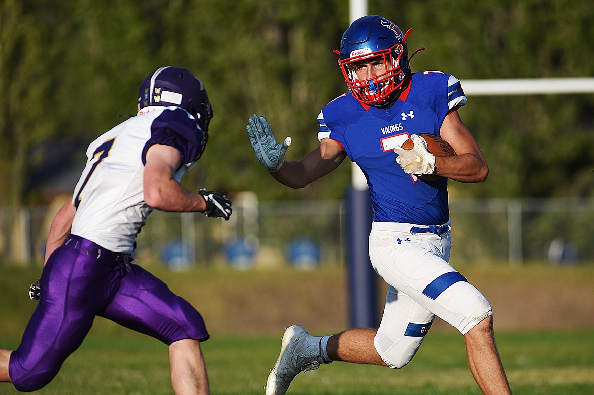 Bigfork running back Cormac Benn (7) extends a stiff-arm to Cut Bank defensive back Matt Larson (7) during the first quarter at Bigfork High School on Friday. (Casey Kreider/Daily Inter Lake)