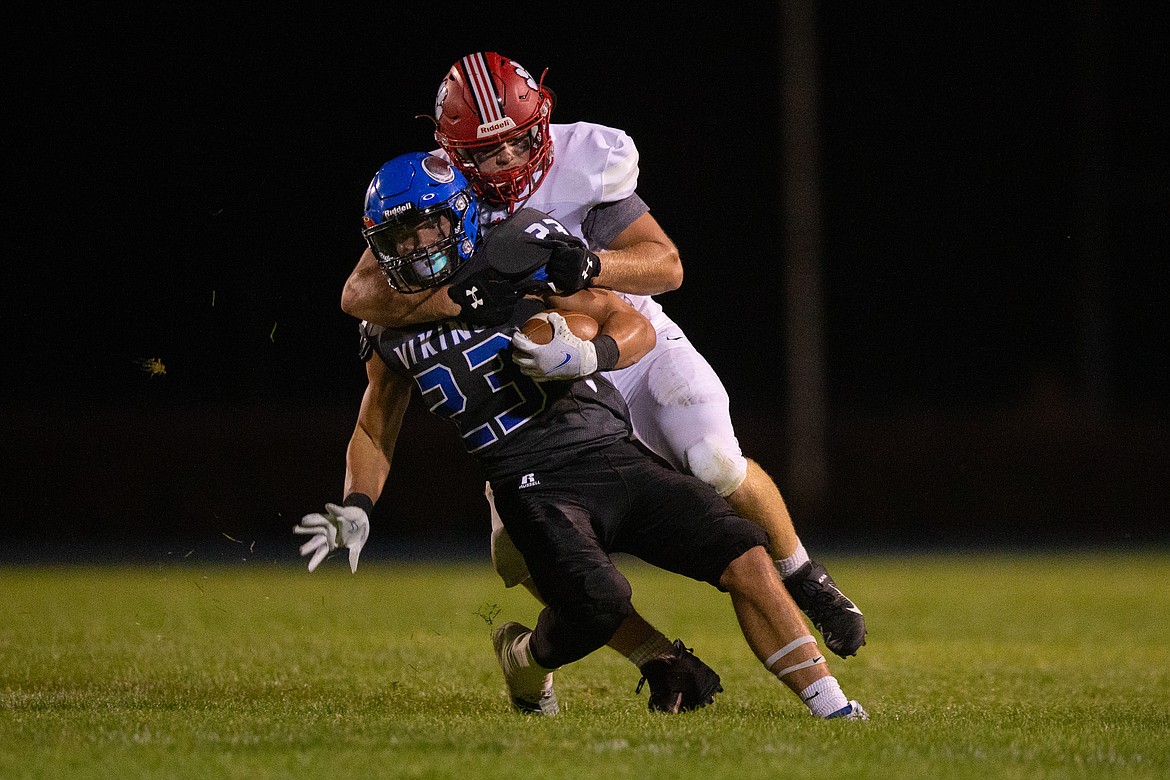 Senior Tag Benefield tackles Coeur d'Alene's Gunner Giulio during a game on Sept. 4 at Viking Stadium.
