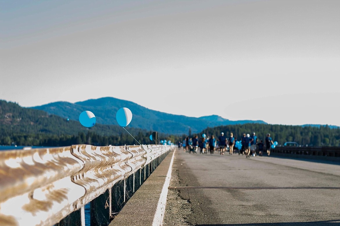 Participants in a past Walk for HOPE head down the Long Bridge walking path to raise awareness of suicide and suicide prevention.