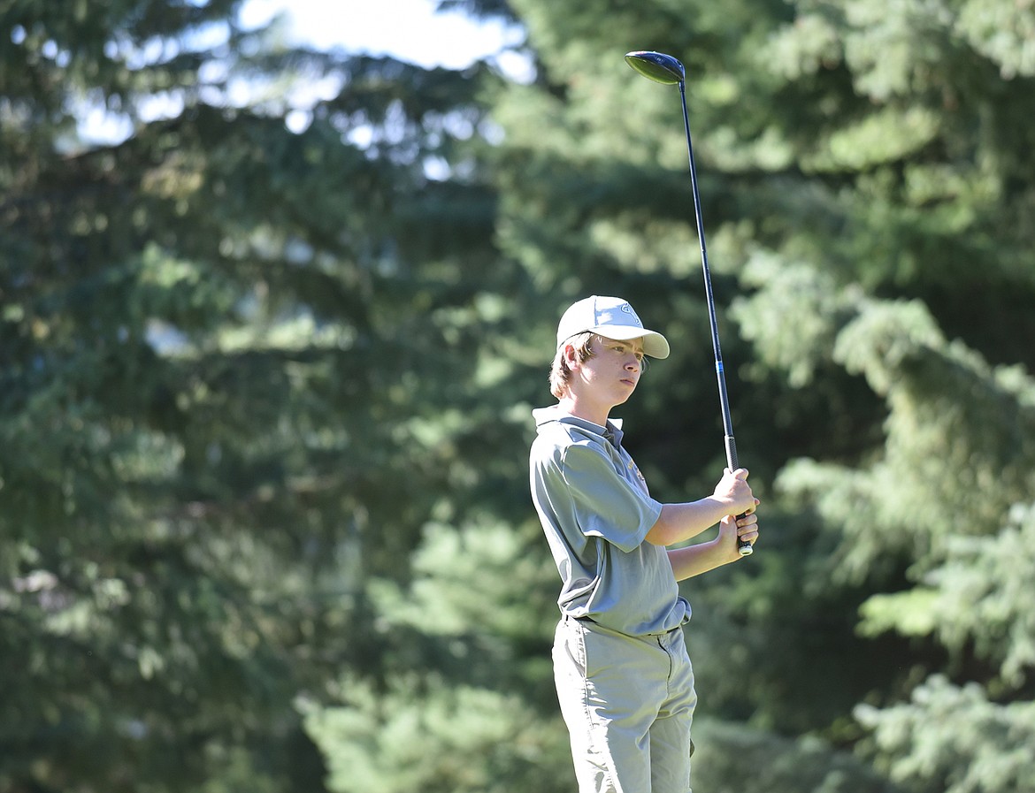 Bulldog Bjorn Olson watches his shot during the Whitefish Triangular tournament last week at Whitefish Lake Golf Club. (Heidi Desch/Whitefish Pilot)