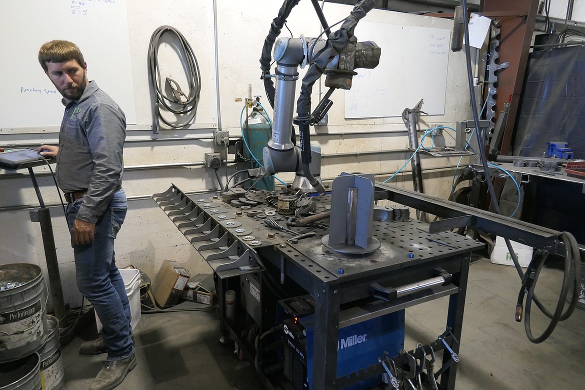 MT Solar President Travis Jordan demonstrates the preparation of parts for the company’s new robot to weld.