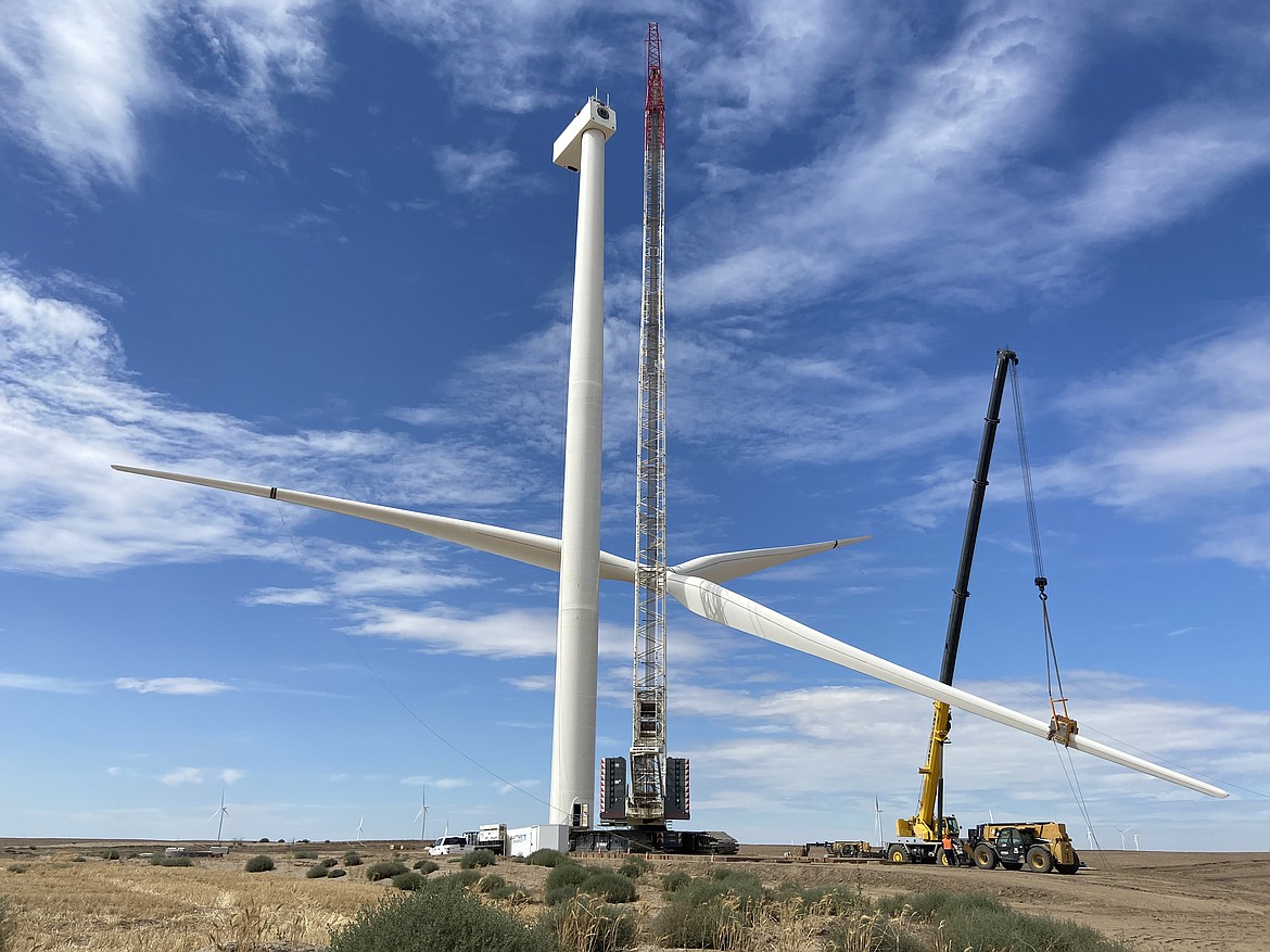 Workers with Clearwater Energy lift wind tower blades on Rattlesnake Flat in August.
