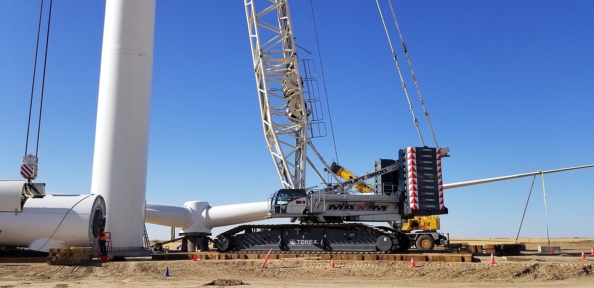 Workers with Clearwater Energy assemble a wind tower on Rattlesnake Flat in July.