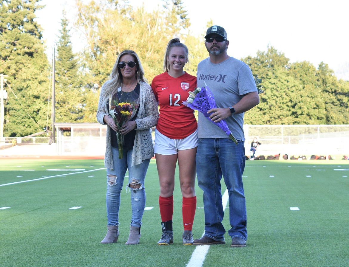 Aspen Larson poses for a photo with her family on senior night.
